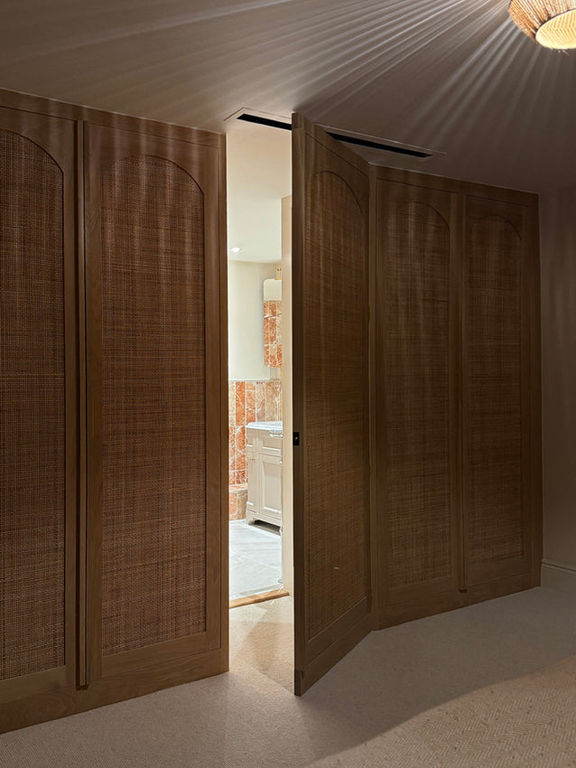 Cotswolds - rattan and oak double wardrobes with secret door through to the ensuite