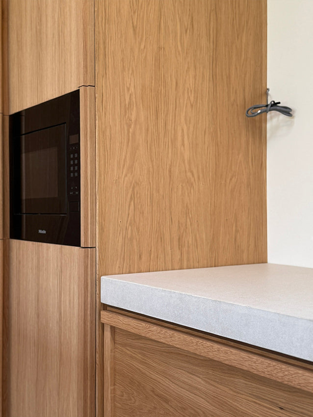 Maidstone - beautiful textures juxtaposed ...oak larder and drawers against a 75mm concrete worksurface by Woody's Concrete Co