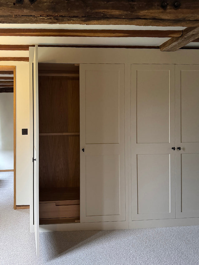 Maidstone - the first of our fitted wardrobes are being installed. Bronze ironmongery, Farrow and Ball Stony Ground, oak drawers with custom routed handles, and oak clothes rails