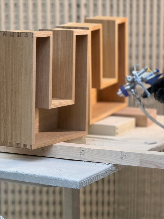 Workshop - solid oak dovetail drawers being sprayed with a protective lacquer